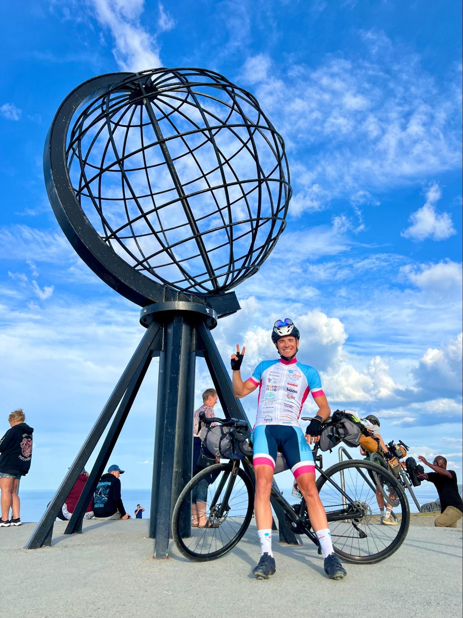 Žiga at North Cape with his bicycle after completing the race